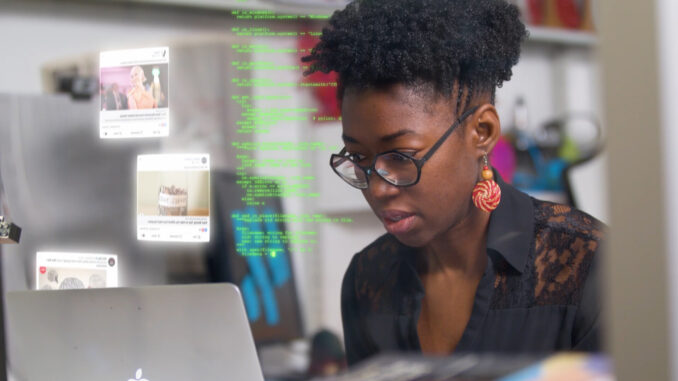 Joy Buolamwini, founder of the Algorithmic Justice League, analyzes AI technology in Coded Bias. Image courtesy of Together Films. Coded Bias